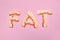 Fat word made of bacon isolated on pink