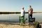 Father and adult son fishing together from riverside