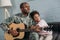 Father in army uniform playing guitar