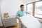 Father arranging baby bed with mattress at home