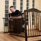 Father assembles new crib