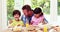 Father assisting children while eating lunch