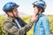 Father attaching his son cycling helmet