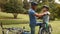 Father attaching his son cycling helmet in the park