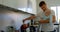 Father and baby boy preparing coffee in kitchen 4k