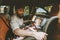 Father and baby in car child sitting in safety seat