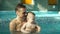 Father and baby in the pool