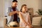 Father braiding daughter hair at home