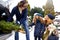 Father brought christmas tree in large trunk of SUV car. Daughter, mother and dog meet dad happily help him with