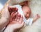 Father carefully keep newborn baby\'s foot