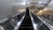 Father carries his son asleep Standing on escalator at The purple line separate sky train station , Nonthaburi in Thailand
