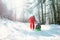 Father carries the sled with his little daughter on the snow slope in winter forest