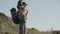 Father carrying his son on shoulders while hiking in mountains.