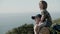 Father carrying his son on shoulders while hiking at seashore.