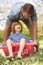 Father Carrying Son Sitting In Laundry Basket