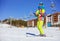 Father carrying tired son in skiing outfit