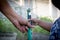 Father and child hand help watering plant in garden