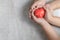 Father and child hands holding red heart on marble