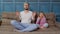 Father and child kid daughter are meditating while sitting in yoga lotus pose on sofa at home room