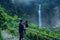 Father and child vacating in the Pelangi waterfall