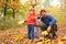 Father with children in autumn wood