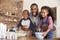 Father And Children Baking Cakes In Kitchen Together