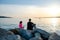 Father with children on a fishing trip by the sea. A boy and a girl with their father have fun fishing on the beach or by the sea.