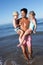 Father And Children Having Fun On Beach