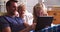 Father With Children Looking At Digital Tablet In Bed