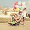 Father and children playing near a house