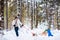 Father and children playing in snow