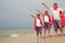 Father and children playing superhero on the beach at the day ti