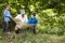 Father and children reading map in nature