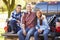 Father And Children Sitting In Truck On Camping Holiday