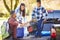 Father And Children Unpacking Truck On Camping Holiday