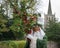 Father Christmas robed in green, masked and carrying holly branc