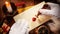 Father Christmas sealing a Christmas letter with a vintage seal and red wax showing his face in a view from above in an olden day