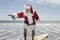 Father Christmas Surfboards At The Water\'s Edge