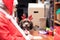 Father Christmas writing a letter on his busy desk with cute dog