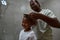 Father combing hair of daughter in bathroom