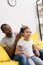 father combing hair of daughter while sitting behind her