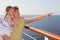 Father on cruise liner deck, carrying daughter