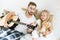 Father and cute little daughter with teddy bear looking at acoustic guitar