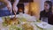 Father cuts a festive fried chicken at the christmas table