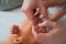 Father cuts the newbornâ€™s nails. Manicure a child close-up. Newborn baby care concept