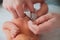 Father cuts the newbornâ€™s nails. Manicure a child close-up. Newborn baby care concept