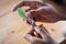 Father cutting fingernails for his baby on wooden table