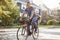 Father Cycling Along Street With Daughter In Child Seat