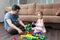 Father and daughter build ball slide tower