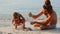 Father and daughter build a sand castle on the seashore